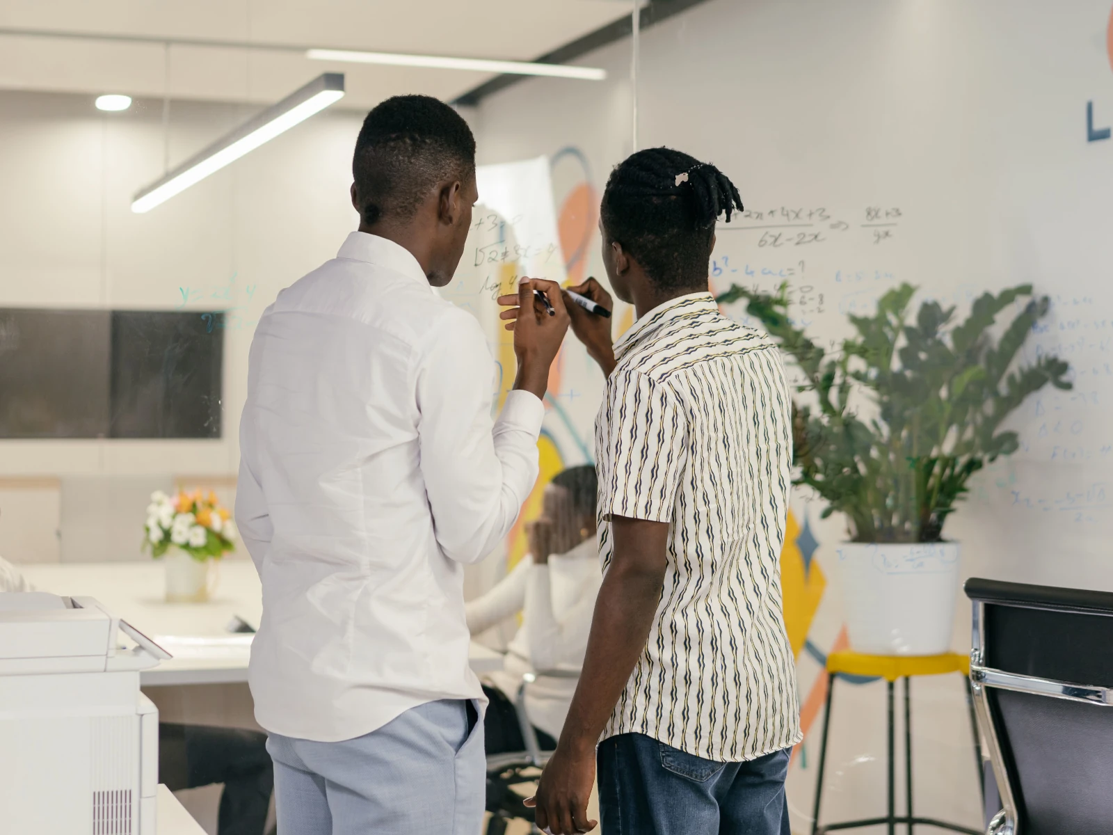 a man holding a paper and a microphone next to another man
