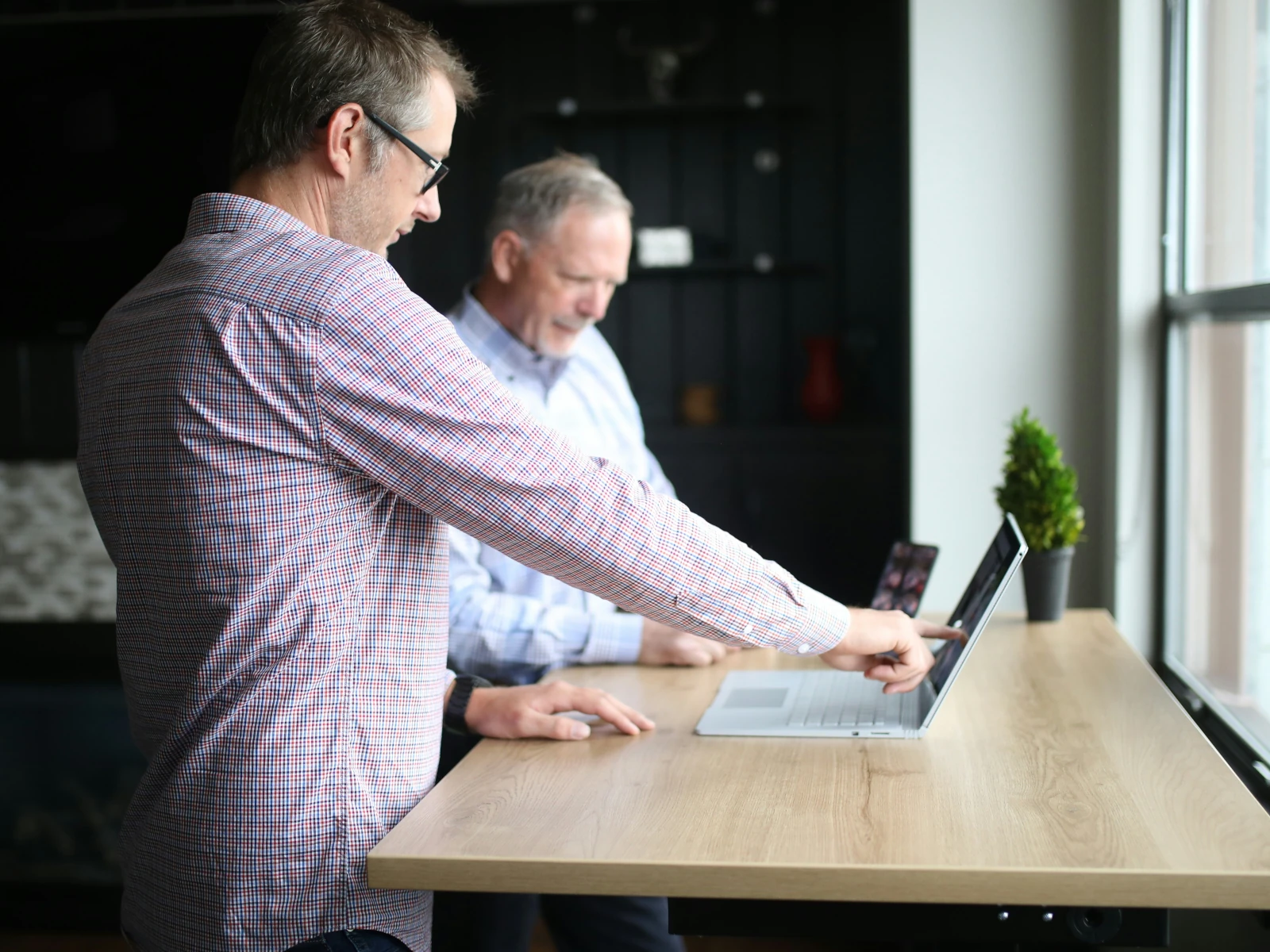 a man and a woman looking at a computer screen