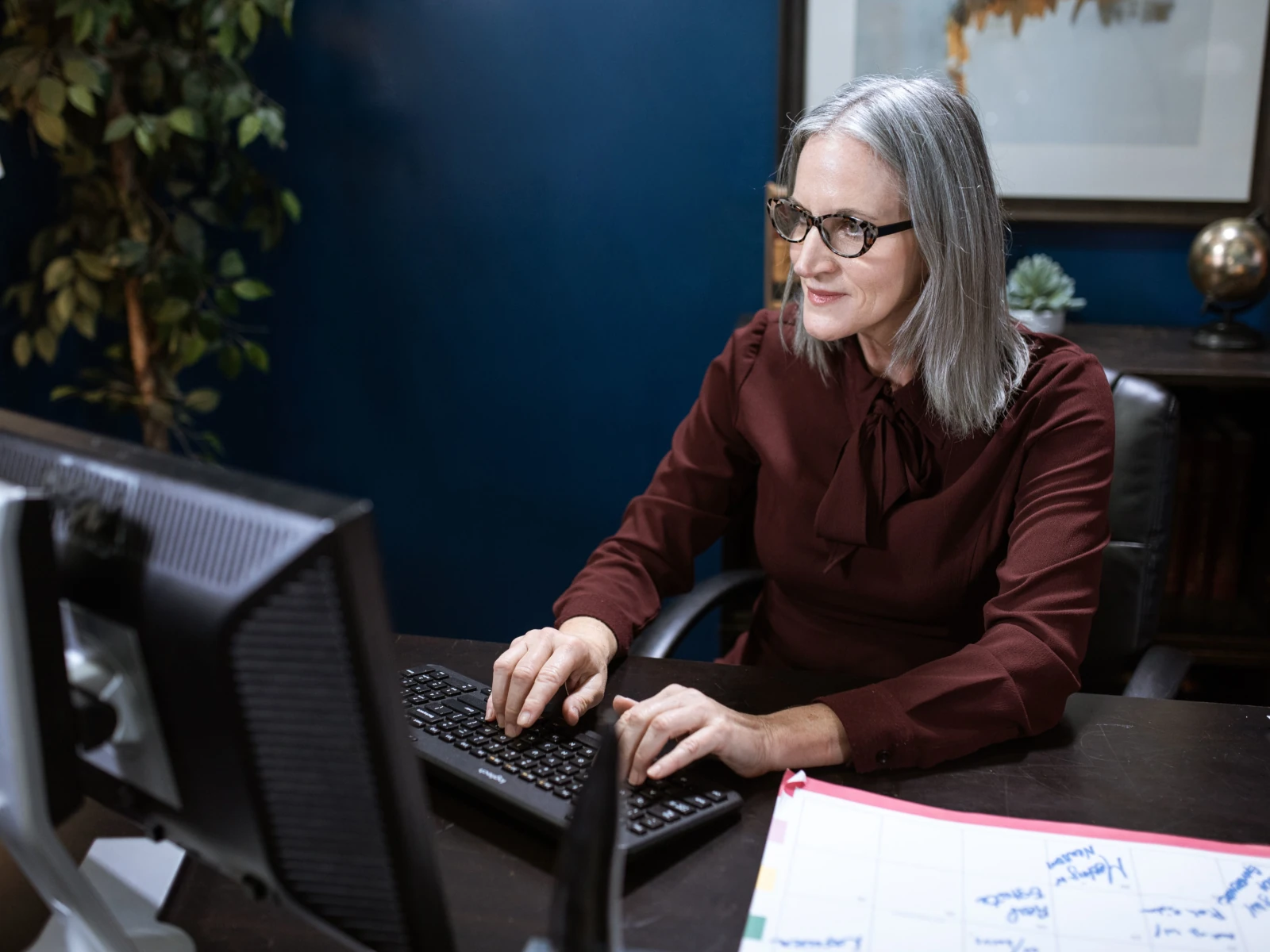 a man and a woman working at computers