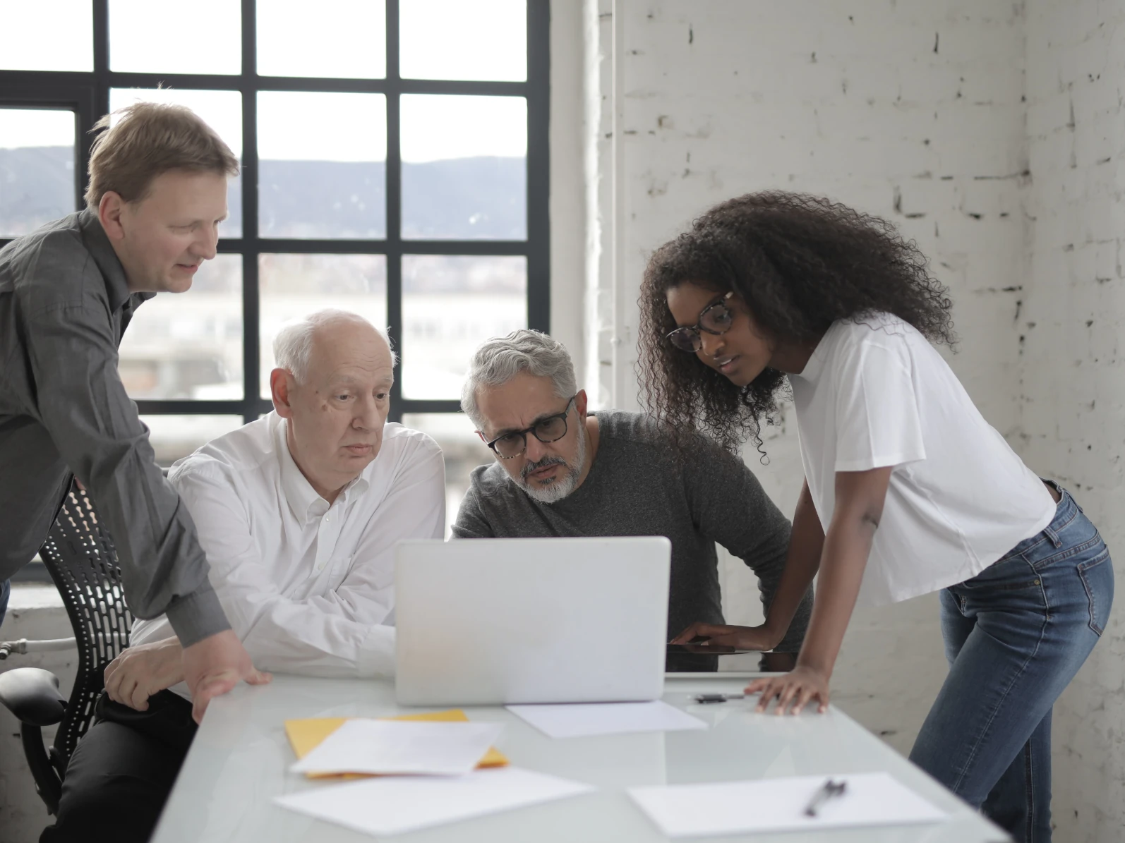 a few people working at a computer