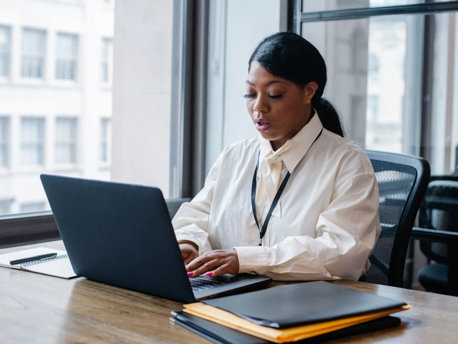 a person sitting at a desk with a laptop