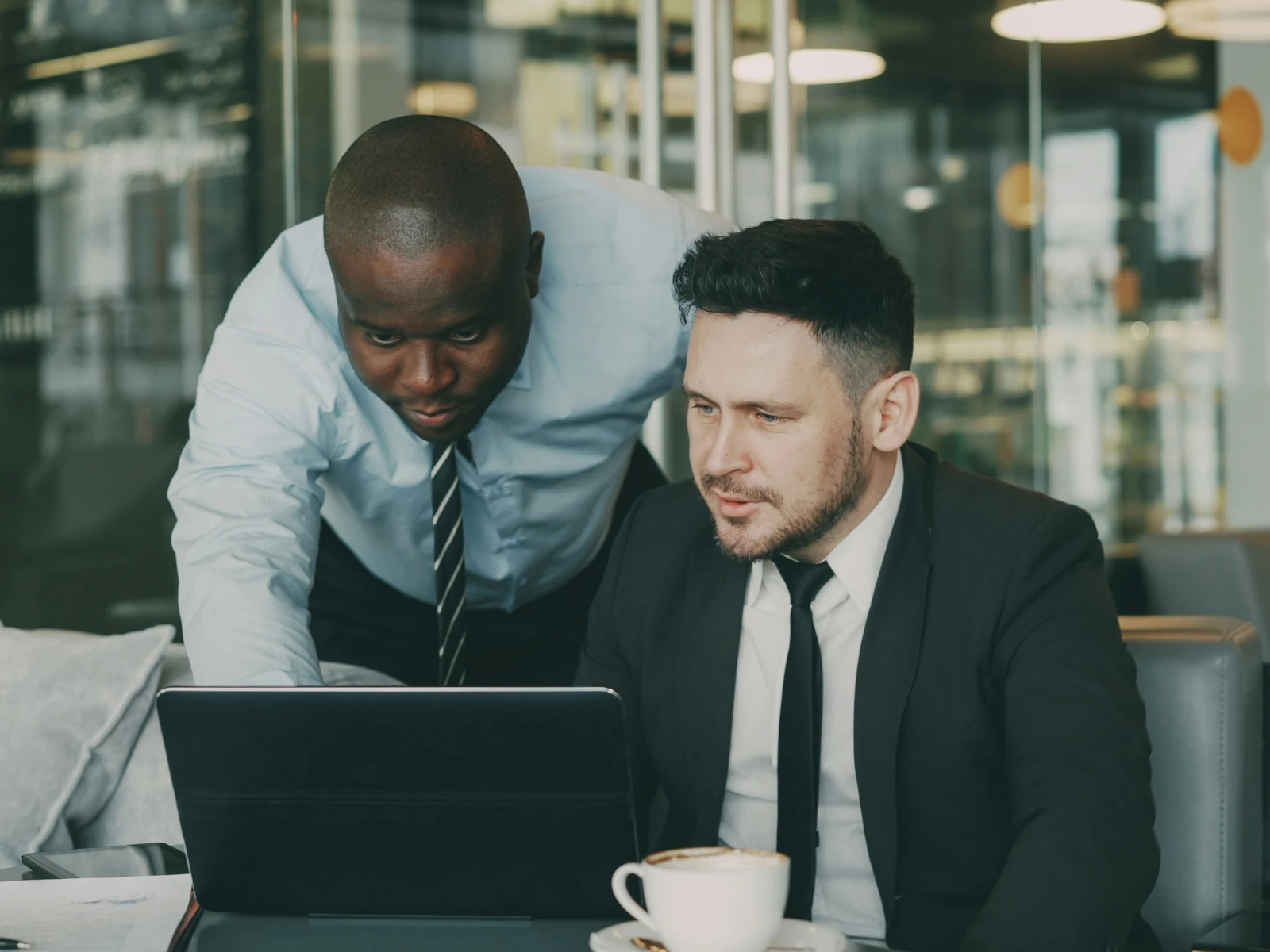 a man and a woman looking at a laptop