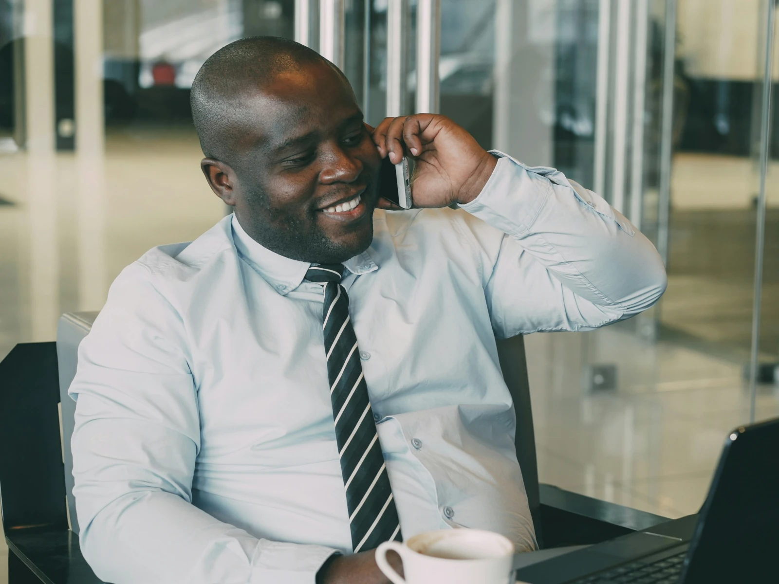 a man wearing headphones and sitting at a desk with a computer