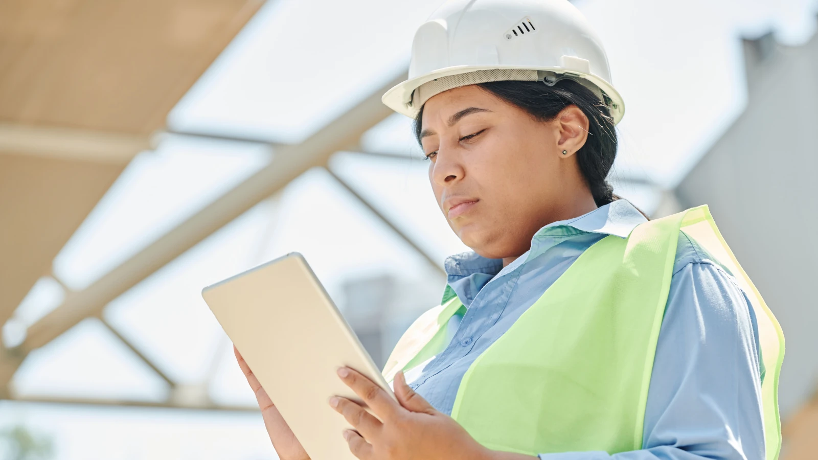 a person in a hard hat holding a tablet