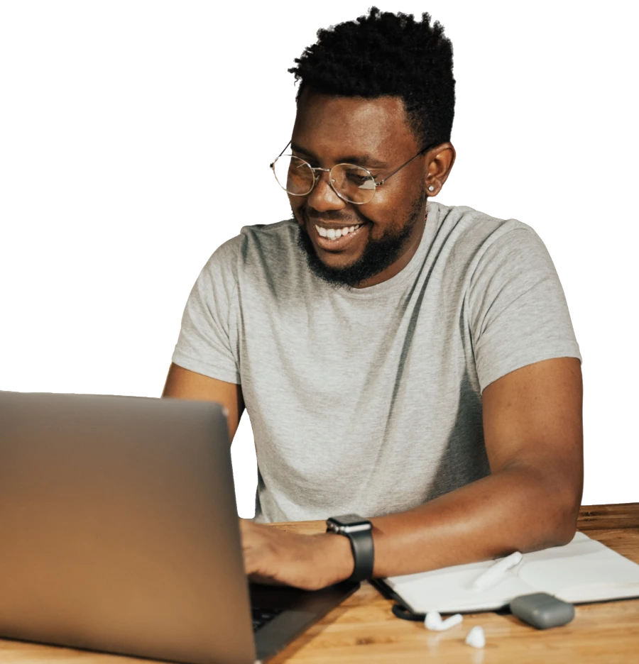 a man sitting at a table with a laptop